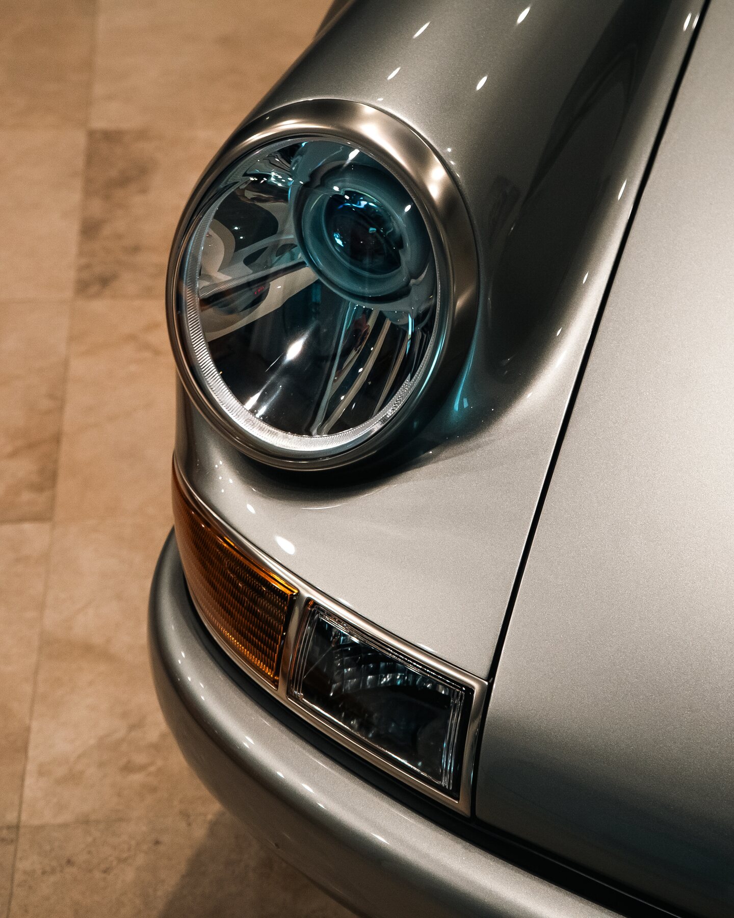 Close view of a Porsche 911 headlight and fender.