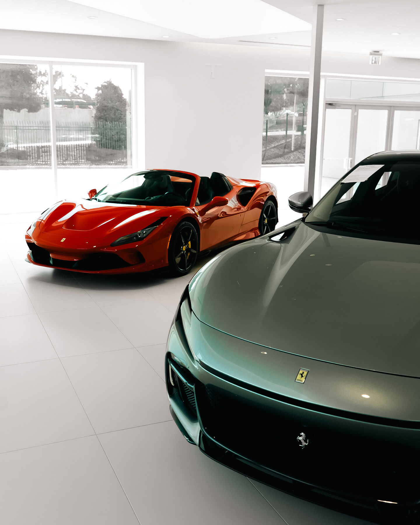 A layered view across several Ferrari models inside the showroom.