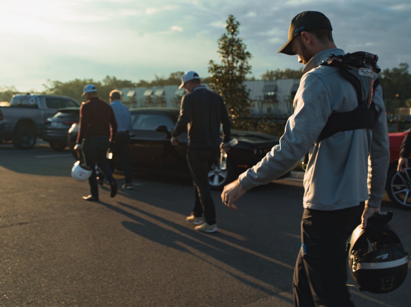 Drivers and crew gathering on the grid during a Construction Services Inc. track event.