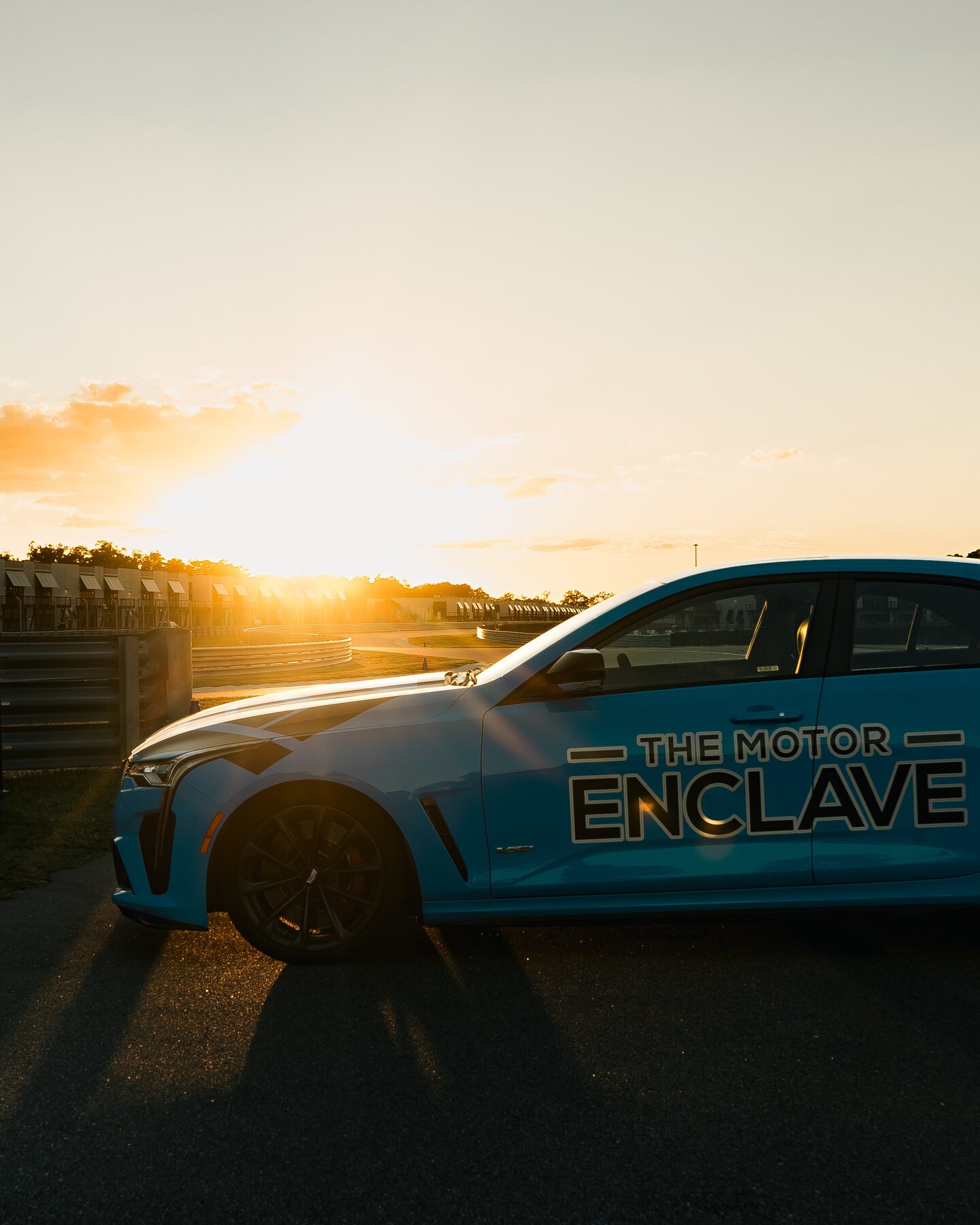 A Motor Enclave-liveried Porsche photographed against the sunset.