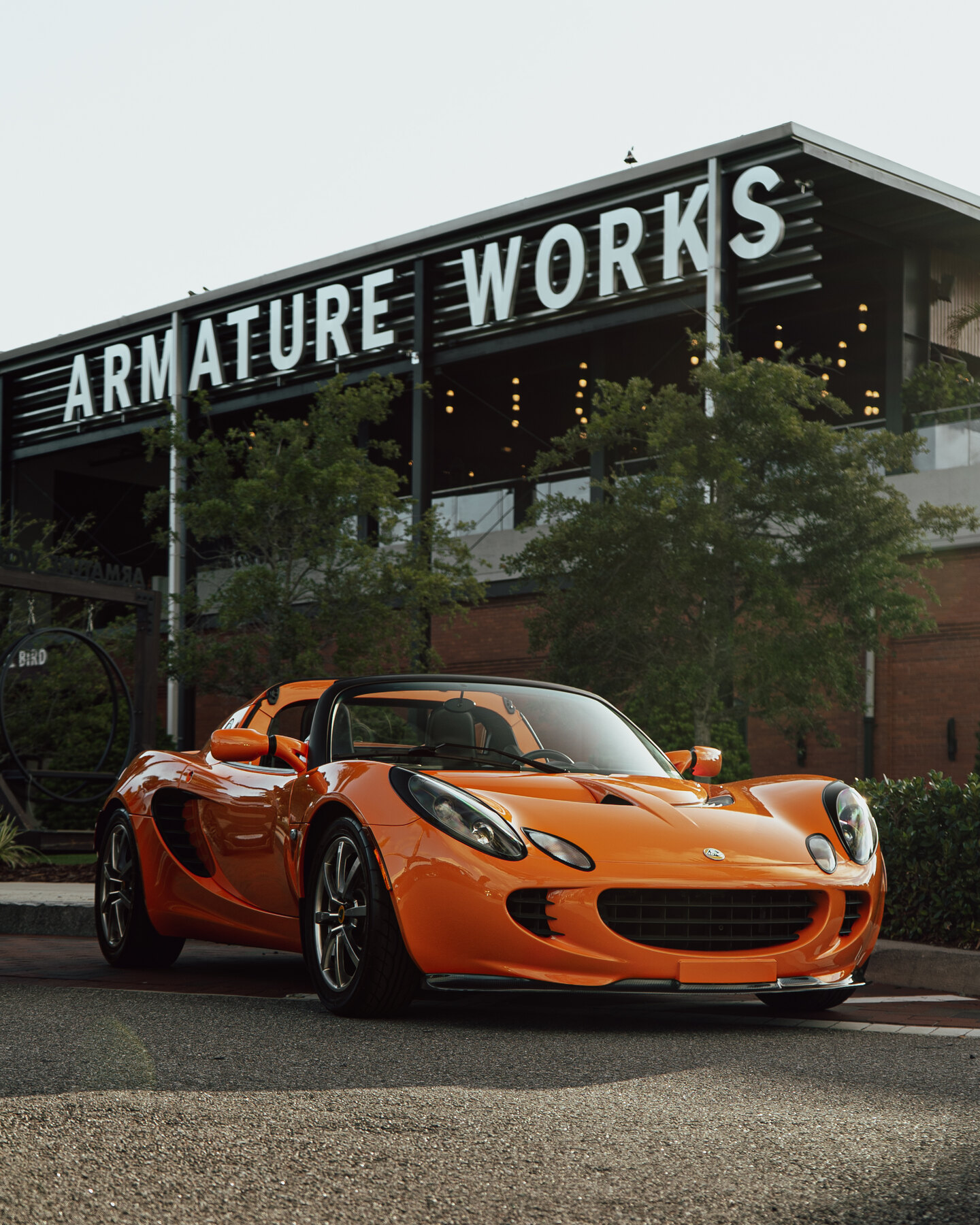 Orange Lotus Elise photographed outside Armature Works in Tampa.